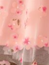 Adorable little girl twirling in a beautiful rosebud garden floral print dress perfect for weddings or a casual day out