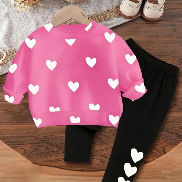 Adorable girls playful set featuring a sweet heart print perfect for fall and winter The outfit includes mention pieces included eg a sweater and leggings in soft comfortable fabrics
