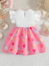 Adorable baby girl wearing a summer heart print dress perfect for school and special occasions