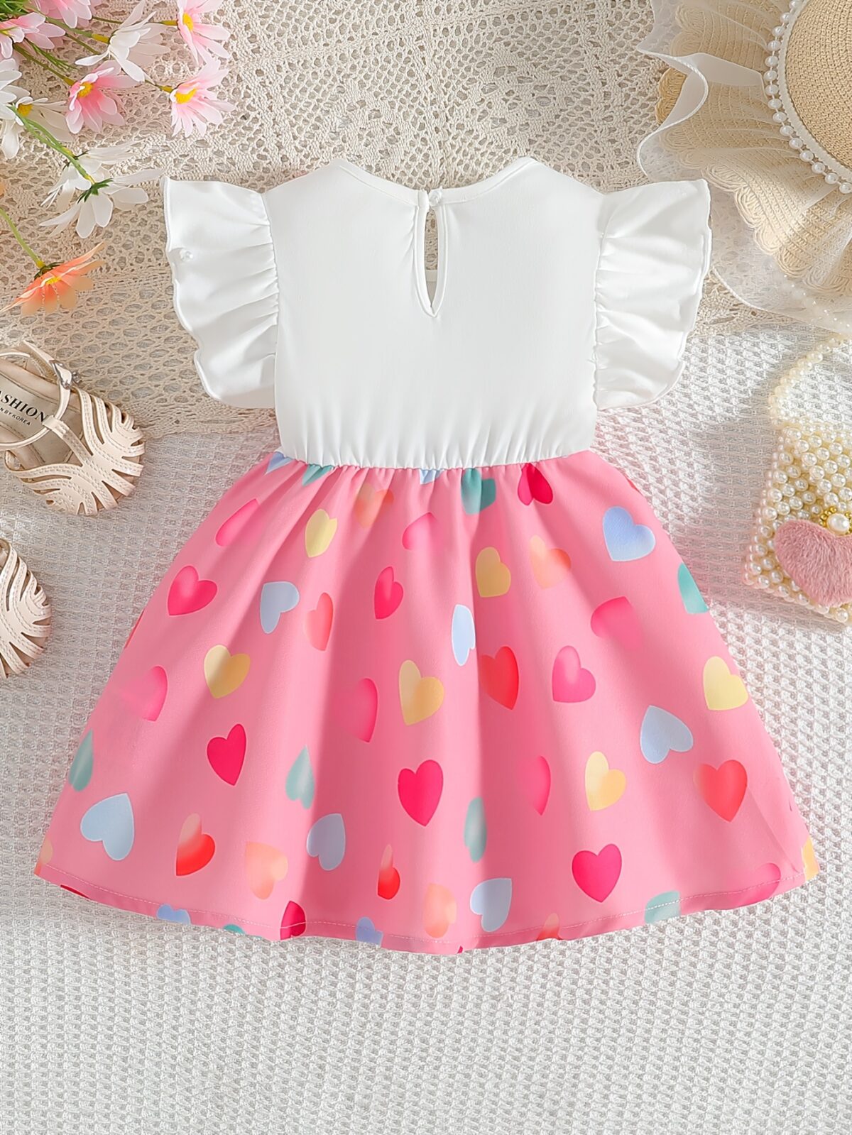 Adorable baby girl wearing a summer heart print dress perfect for school and special occasions