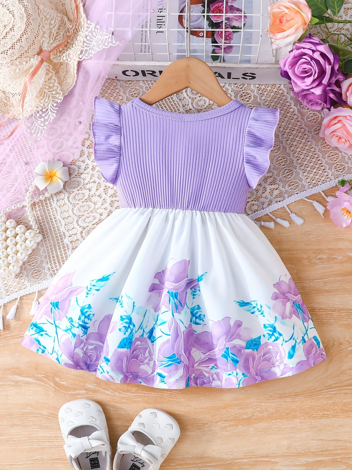 A little girl wearing a charming summer floral print dress