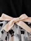 Adorable little girl twirling in a vibrant Summer Bloom floral print dress from Newness perfect for summer