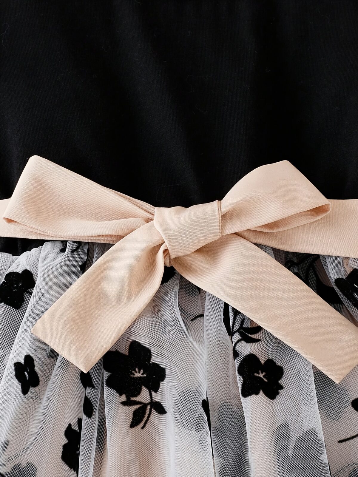 Adorable little girl twirling in a vibrant Summer Bloom floral print dress from Newness perfect for summer