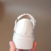 Celestial Bow  Pearl Girls Dress Shoes by Newness Elegant white dress shoes with a delicate bow and pearls perfect for weddings and parties