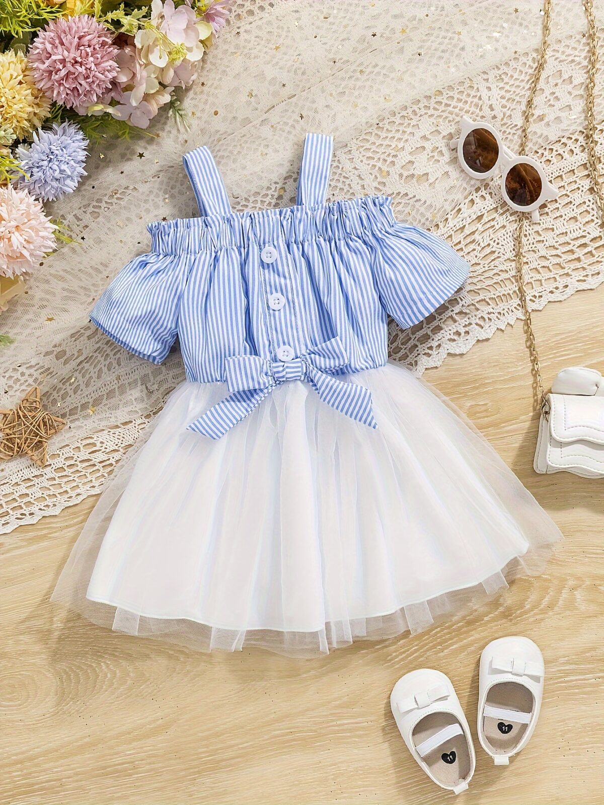 Adorable baby girl wearing a cute and playful summer stripe sundress perfect for playtime