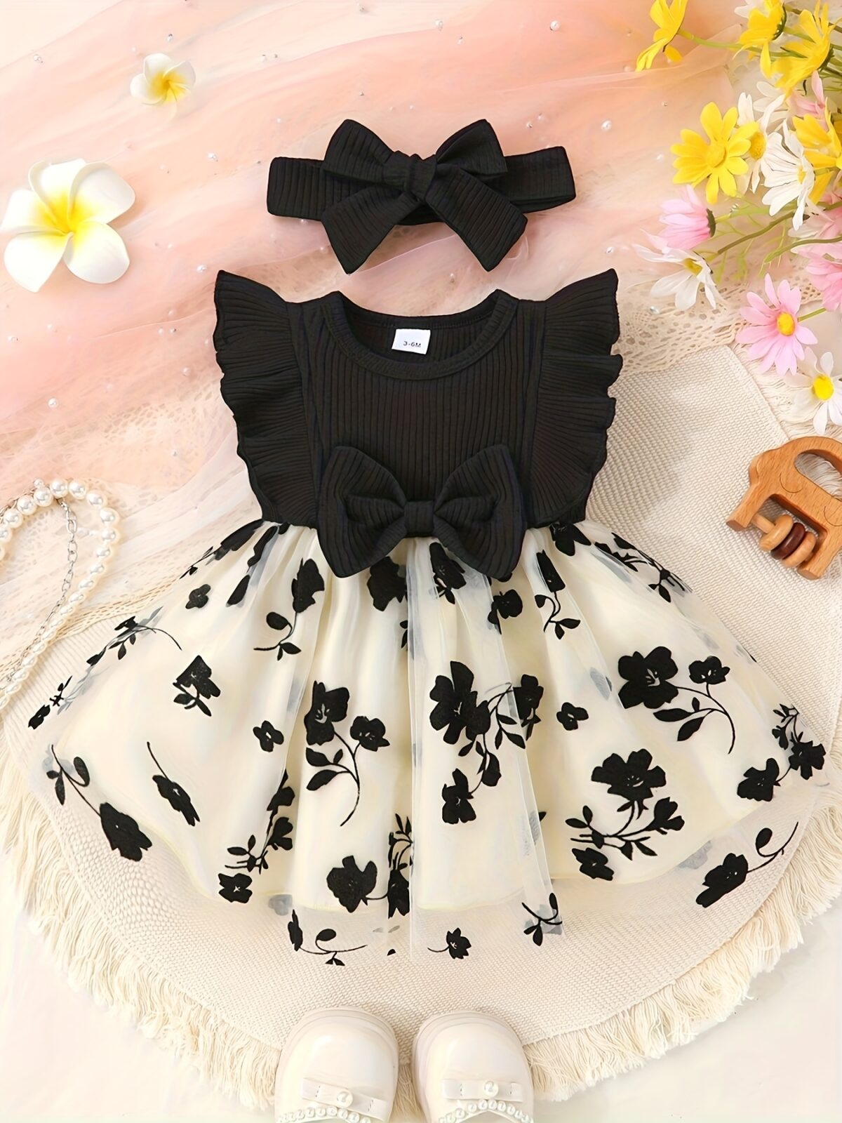 Petite Fleur A charming girl in a floral mesh dress twirling happily