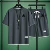 Model wearing the Newness Dubai Nights Mens Casual Sports Set a comfortable and stylish navy blue polyester athletic set perfect for lounging or working out