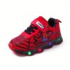 Boy wearing stylish Marvel Spider Man LED light up sneakers running and playing The sneakers light up showcasing vibrant colors