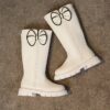 Stylish and warm girls fleece lined bow snow boots perfect for winter adventures The boots are shown from an angle showcasing the fleece lining the bow detail and the durable sole