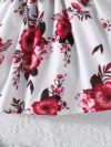 Adorable baby girl wearing a beautiful summer garden floral print dress
