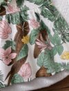 Baby girl wearing adorable Island Bloom floral print dress smiling