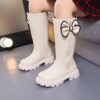 Stylish and warm girls fleece lined bow snow boots perfect for winter adventures The boots are shown from an angle showcasing the fleece lining the bow detail and the durable sole