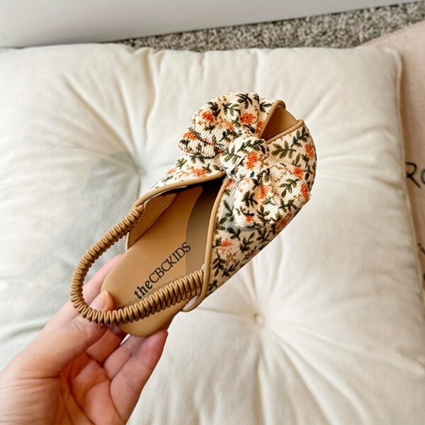Close up of girls cute flat sandals in pink showing detail and comfort