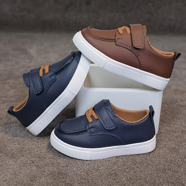 Close up of stylish brown leather boys loafers showcasing the stitching and buckle detail