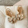 Close up of girls cute flat sandals in pink showing detail and comfort