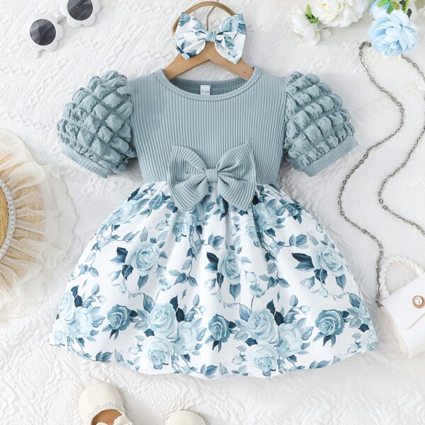 Adorable baby girl wearing a charming Seraphina floral print dress perfect for summer