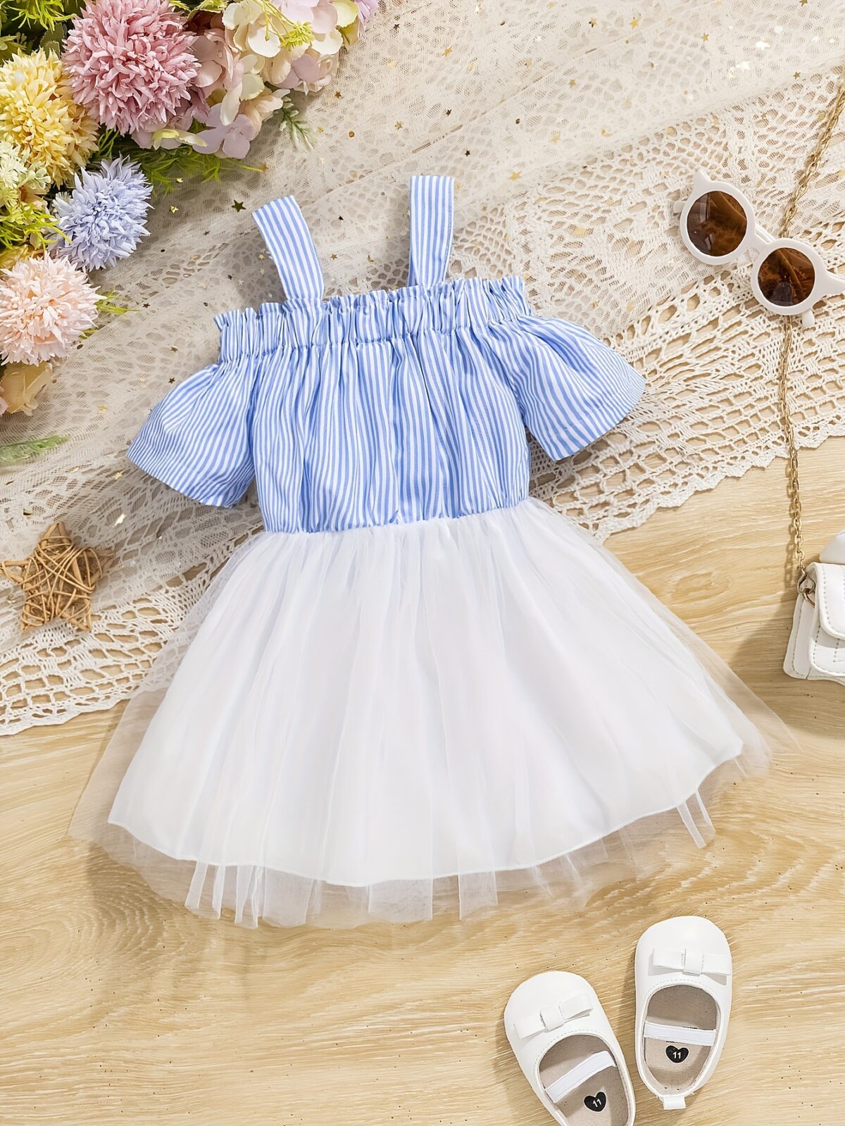 Adorable baby girl wearing a cute and playful summer stripe sundress perfect for playtime