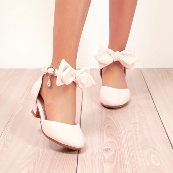 Enchanted Bow Girls White Heels by Newness Stylish and comfortable white heels with a charming bow detail perfect for any occasion