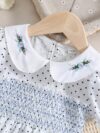 Adorable little girl twirling in a charming summer polka dot dress perfect for birthdays and special occasions