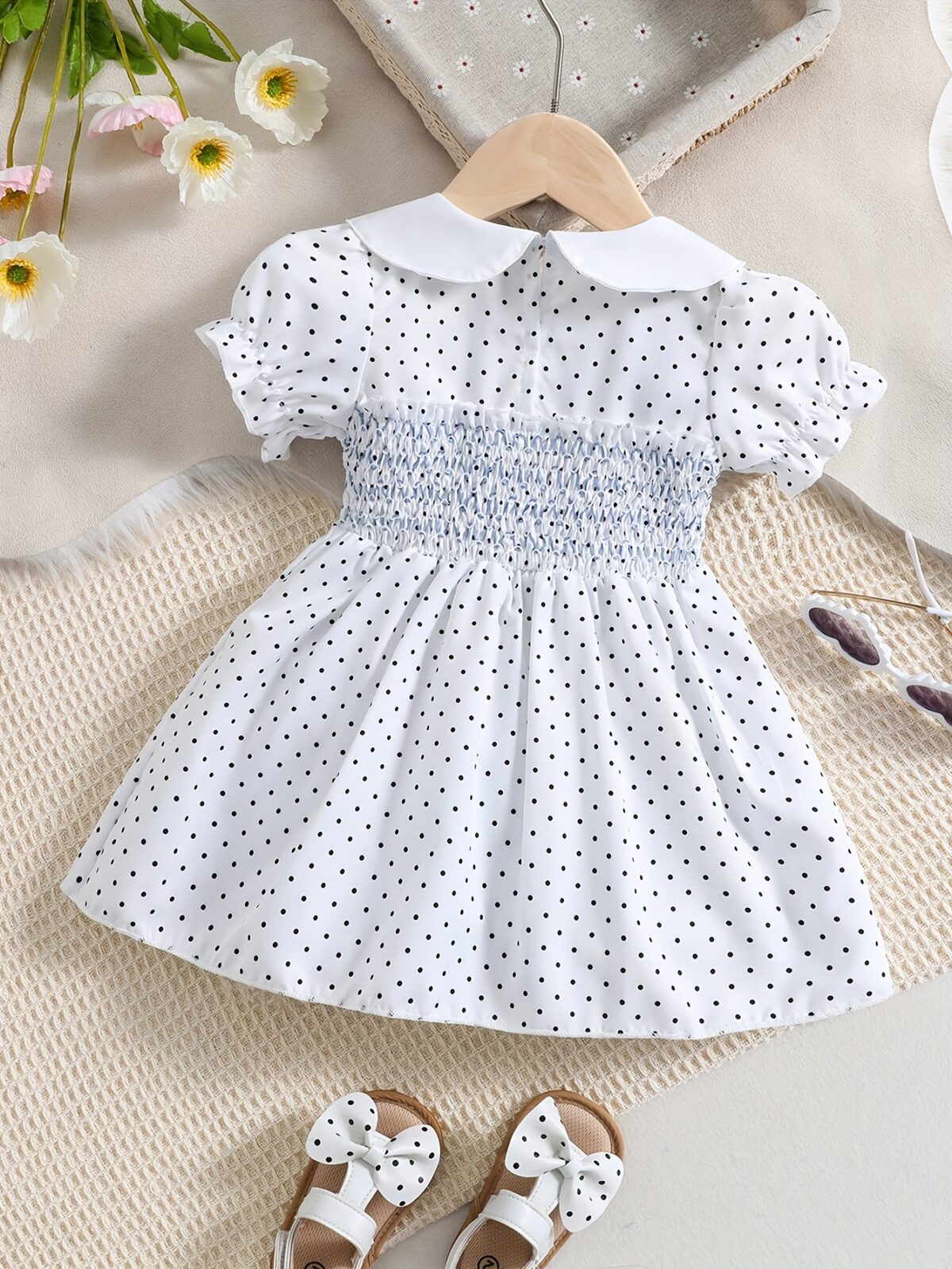 Adorable little girl twirling in a charming summer polka dot dress perfect for birthdays and special occasions