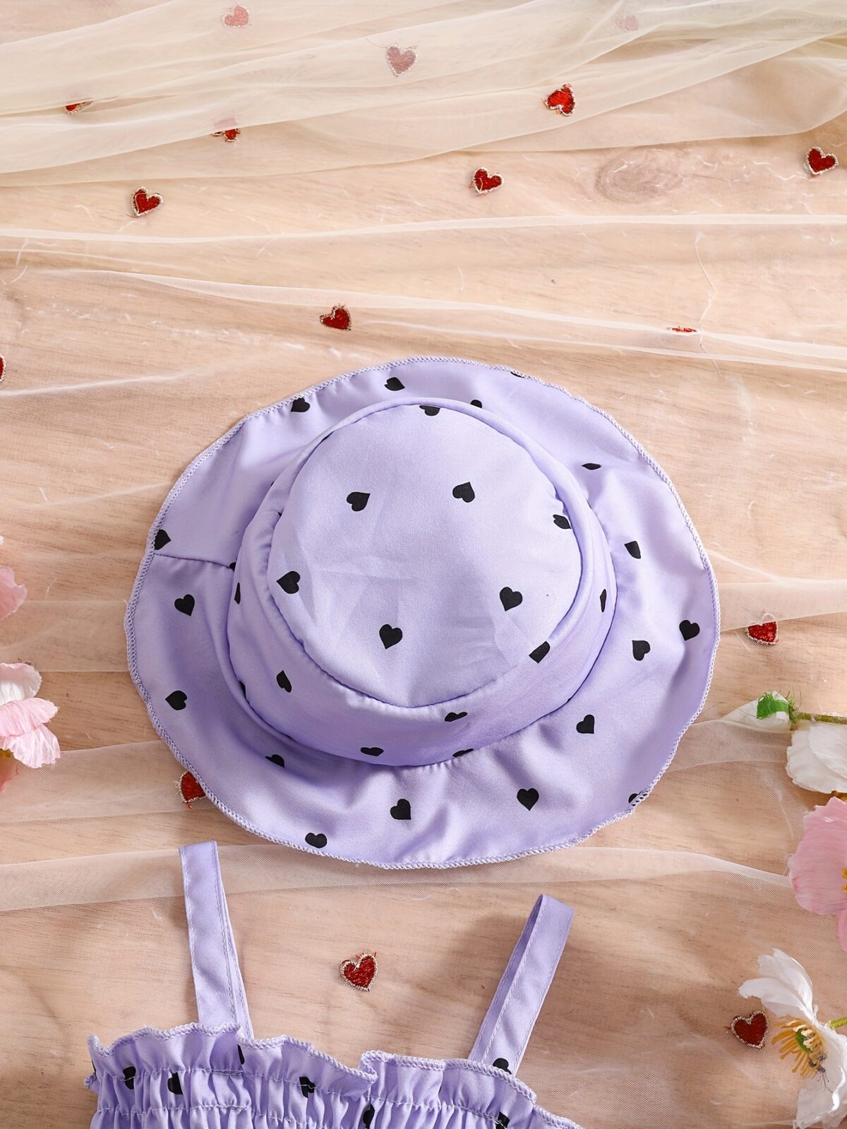 Girl wearing adorable Summer Bloom heart print dress and matching hat set