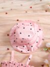 Girl wearing adorable Summer Bloom heart print dress and matching hat set