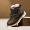 Child wearing stylish and warm Newness Adventure Ready Kids Snow Boots playing in the snow