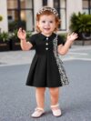 Adorable baby girl in a stylish and comfortable summer dress from Newness perfect for a playdate