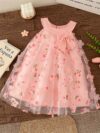 Adorable little girl twirling in a beautiful rosebud garden floral print dress perfect for weddings or a casual day out