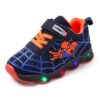 Boy wearing stylish Marvel Spider Man LED light up sneakers running and playing The sneakers light up showcasing vibrant colors