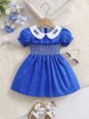 Adorable little girl twirling in a charming summer polka dot dress perfect for birthdays and special occasions