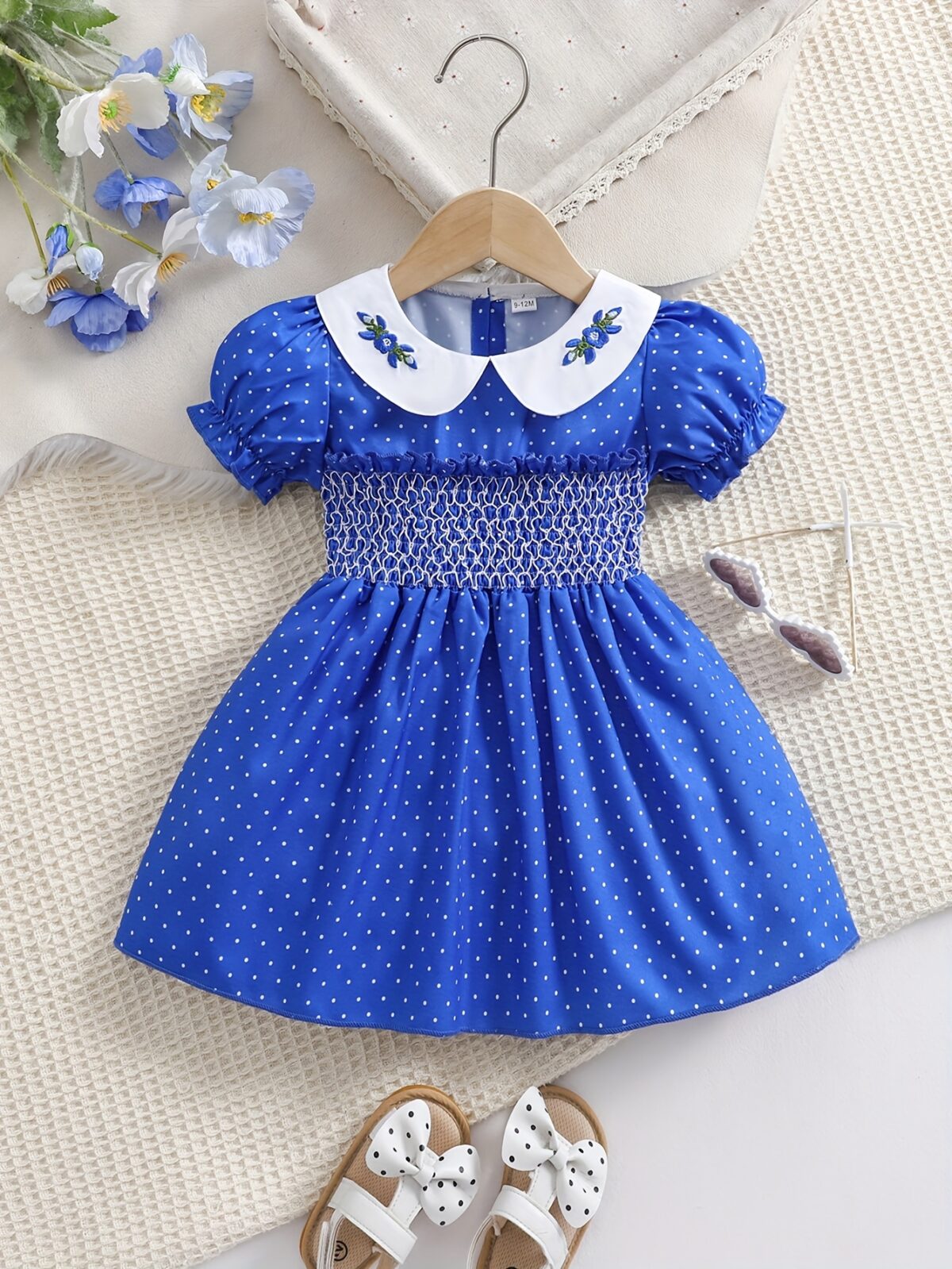 Adorable little girl twirling in a charming summer polka dot dress perfect for birthdays and special occasions