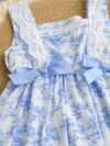 Model wearing a charming Provence Summer Bow Dress in a field of flowers The dress features a flattering silhouette and a cute bow