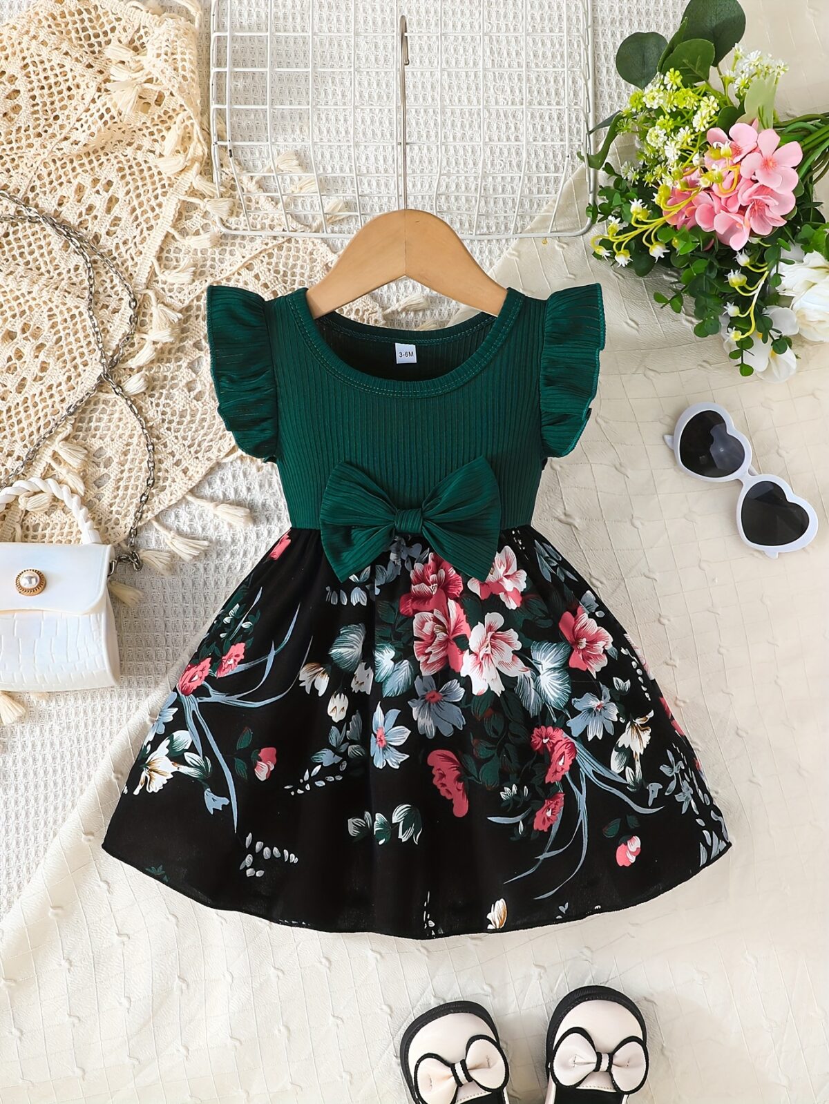 Adorable girl wearing a vibrant Summer Bloom floral print dress perfect for summer The dress features a playful colorful floral pattern