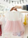 Adorable little girl twirling in a pink Summer Bloom Rose Princess Dress from Newness showcasing its comfortable and stylish design