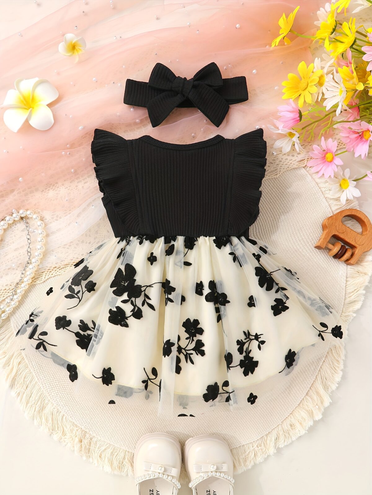 Petite Fleur A charming girl in a floral mesh dress twirling happily