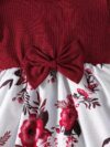 Adorable baby girl wearing a beautiful summer garden floral print dress