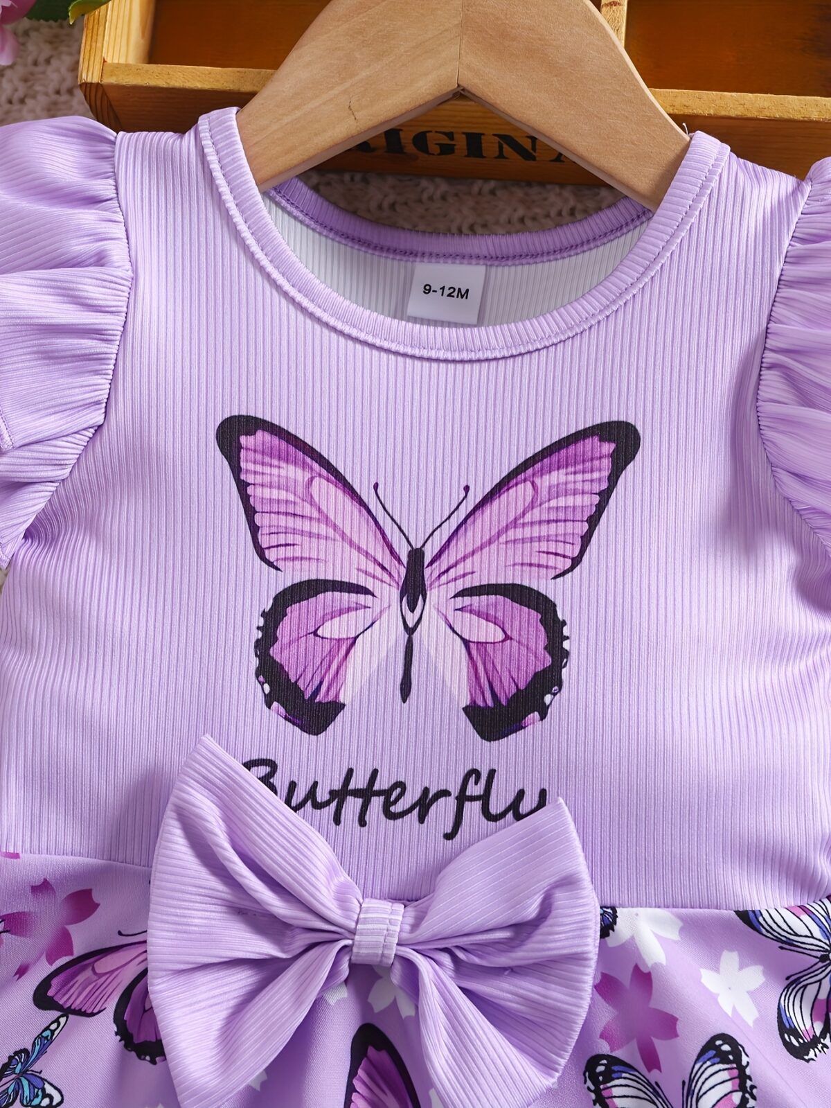 Adorable baby girl in a lavender butterfly dress perfect for summer Newness