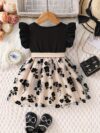 Adorable little girl twirling in a beautiful summer floral mesh dress from Newness The dress is lightweight and perfect for warm weather