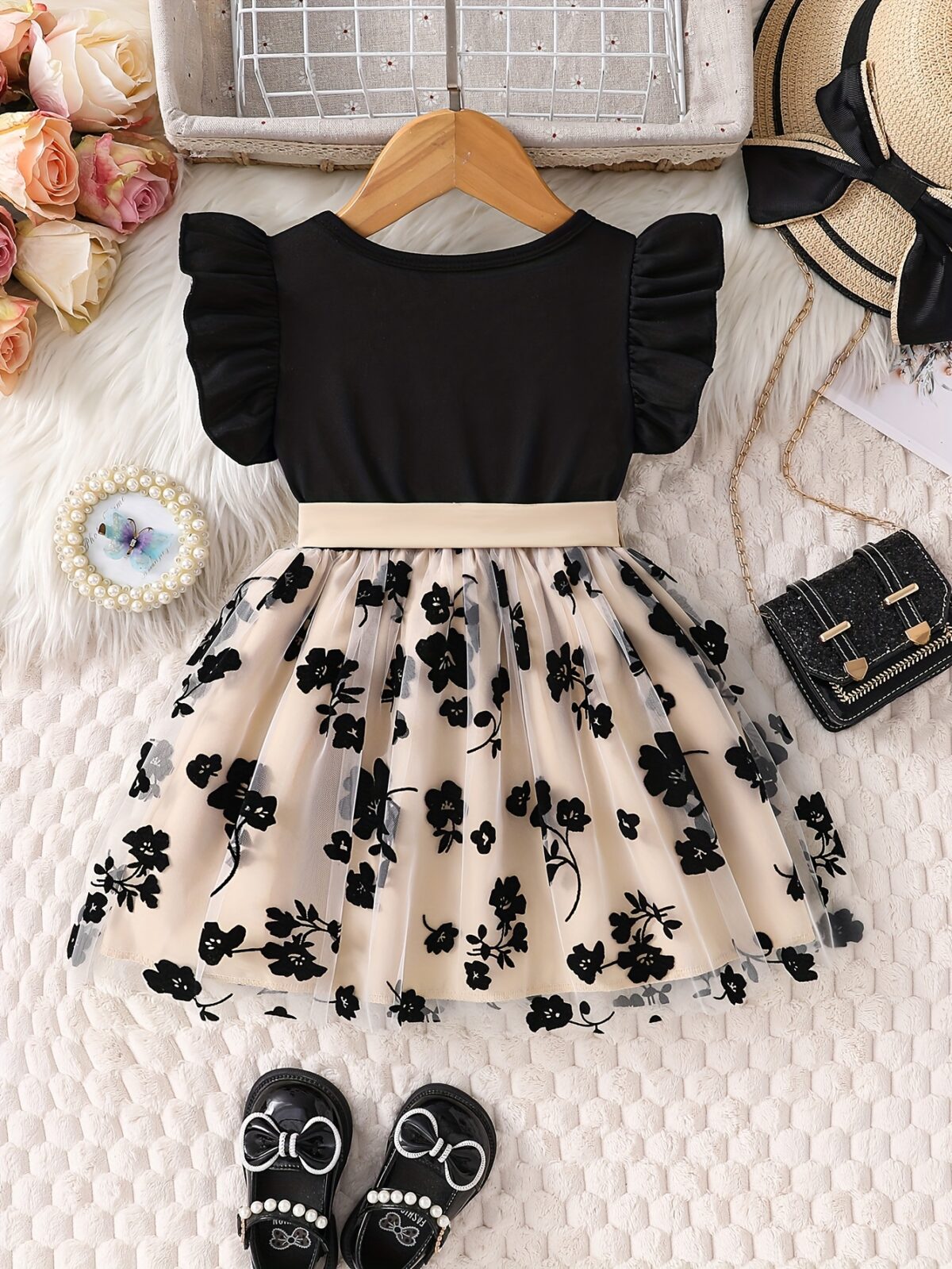 Adorable little girl twirling in a beautiful summer floral mesh dress from Newness The dress is lightweight and perfect for warm weather