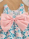 Adorable girl wearing a beautiful floral print summer dress perfect for a beach party