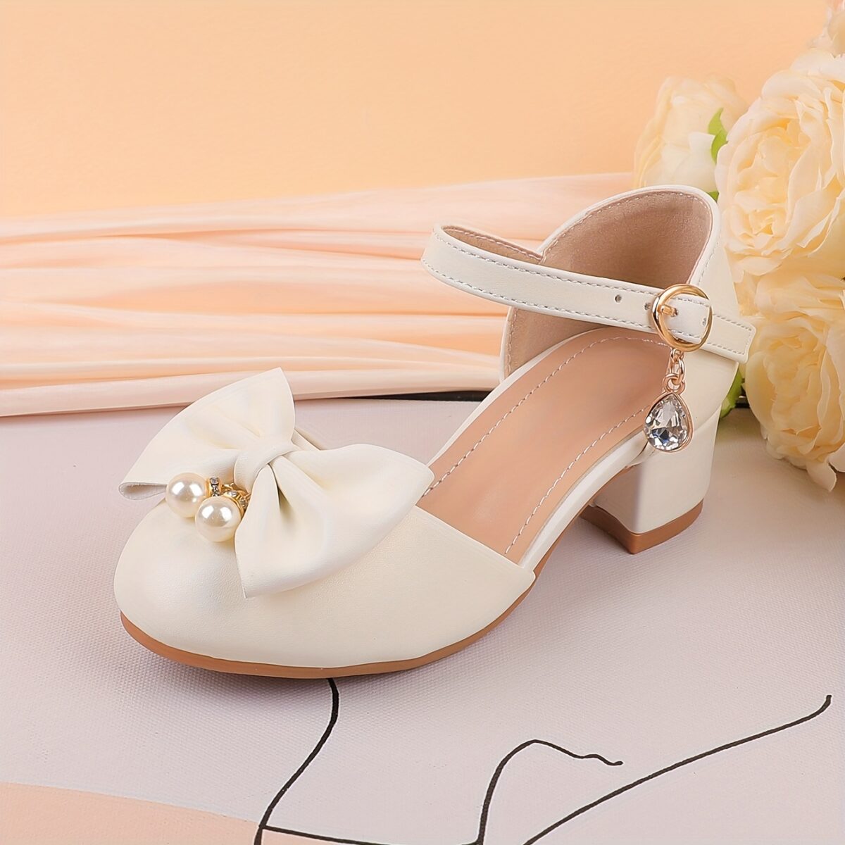 Adorable girls Pearl  Bow Mary Janes in white perfect for weddings parties and special occasions Featuring delicate pearls and charming bows