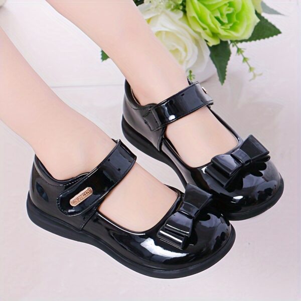 Stylish and comfortable Classic Bow Girls School Shoes in black patent leather with a classic bow detail perfect for school parties and other occasions