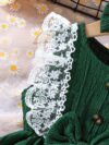 Toddler girl wearing a charming emerald green summer dress ideal for playing outdoors