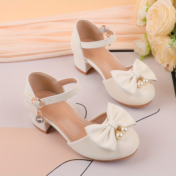 Adorable girls Pearl  Bow Mary Janes in white perfect for weddings parties and special occasions Featuring delicate pearls and charming bows