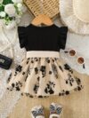 Adorable little girl twirling in a beautiful summer floral mesh dress from Newness The dress is lightweight and perfect for warm weather