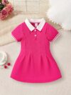 Adorable baby girl in a charming rose patterned summer dress perfect for playdates or special occasions
