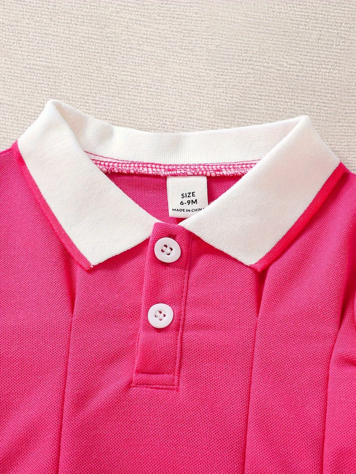 Adorable baby girl in a charming rose patterned summer dress perfect for playdates or special occasions