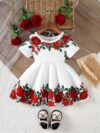 Adorable baby girl wearing a Rosalind floral print dress from Newness The dress features a charming floral pattern and is perfect for special occasions or everyday wear