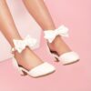 Enchanted Bow Girls White Heels by Newness Stylish and comfortable white heels with a charming bow detail perfect for any occasion